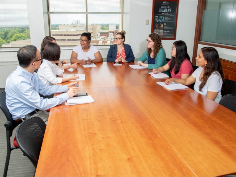 Group of people sitting at a conference table